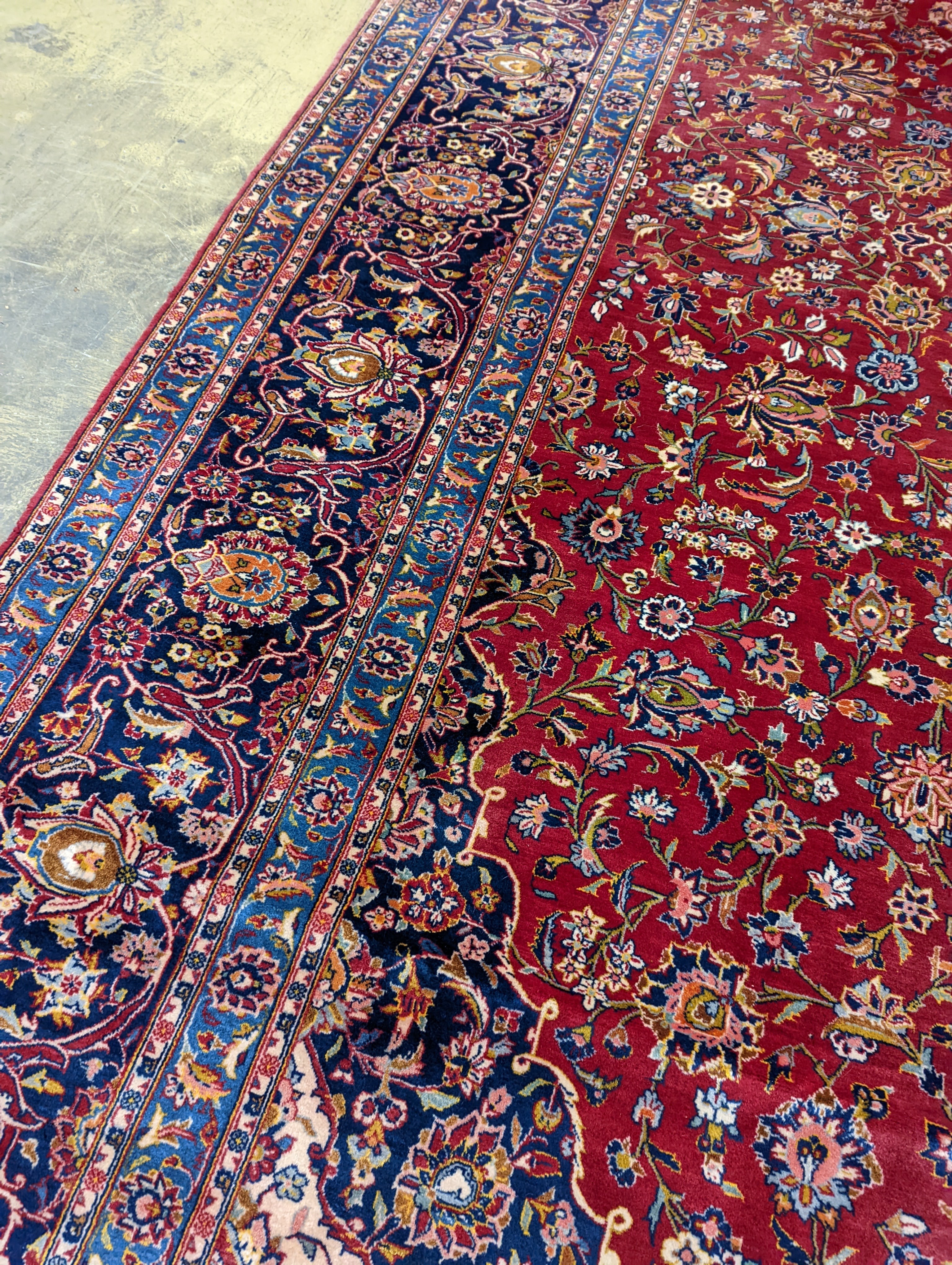 A large Tabriz red ground floral carpet, 540 x 350cm